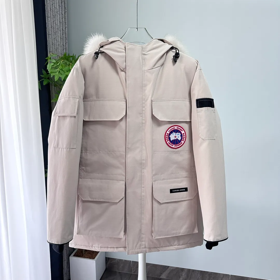 P700 CANADA GOOSE｜Canada Goose Expedition Parka｜Classic upgrade New 08 style Color: graphite gray, off-white, black, pink, navy blue, sky blue, Size: XS, S, M, L, XL, XXL, Product introduction Loose fit, multi-pocket design Larger size for free movement. 6 exterior pockets: 4 reversible front pockets, zippered side entry. There is a practical pocket on the left sleeve and a top pocket on the right sleeve. There is a drawstring on the inside of the waist and a logo patch on the back. The waist is designed with an inside drawstring, which can be adjusted to provide excellent warmth. Woven grab straps at upper back with “Expedition” logo patch • Hood with removable zipper trim, interchangeable hood trim for personalization and added protection (this jacket is not available with the classic hood trim) • Chin protection element has a tricot inner fabric for softness and comfort • Woven grab straps at upper back with “Expedition” logo patch • Internal drawstring at the waist, adjustable to provide excellent warmth •Snap-in rib knit cuffs for added comfort and optimal heat locking in •Stylish hanging inner straps allow the jacket to be carried over the shoulder, hands-free •Stowaway nylon stretch snow skirt for added protection •Two-way zipper covered fly with Velcro® snaps that unzips from the bottom for increased range of motion and breathability. A windproof fly is designed under the zipper for an extra layer of protection. • 6 exterior pockets: 4 two-way pockets on the front with top flap and Velcro® snaps, and zippered side entry. Utility pockets on left sleeve and right sleeve with top flap and velcro® snaps Internal pockets: 1 zipped pocket, 2 mesh drop-in pockets Embroidered Canada Goose logo